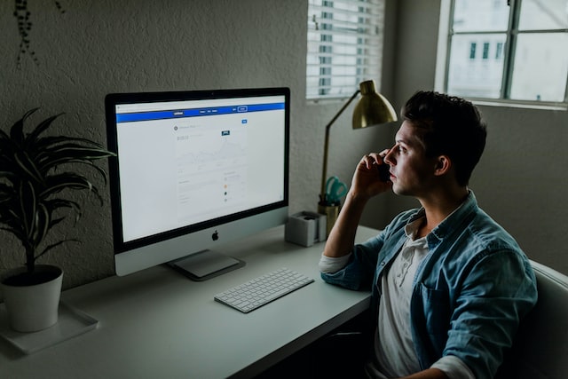 Person sitting in front of a desktop computer